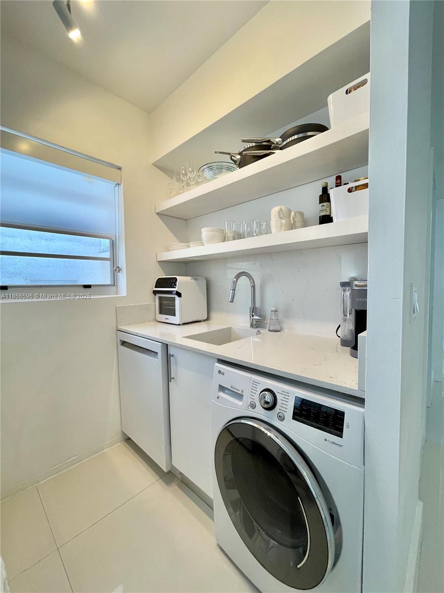 1604 Drexel Avenue, Unit 209 Miami Beach, FL 33139 - Photo 4 of 9 a utility room with sink dryer and washer