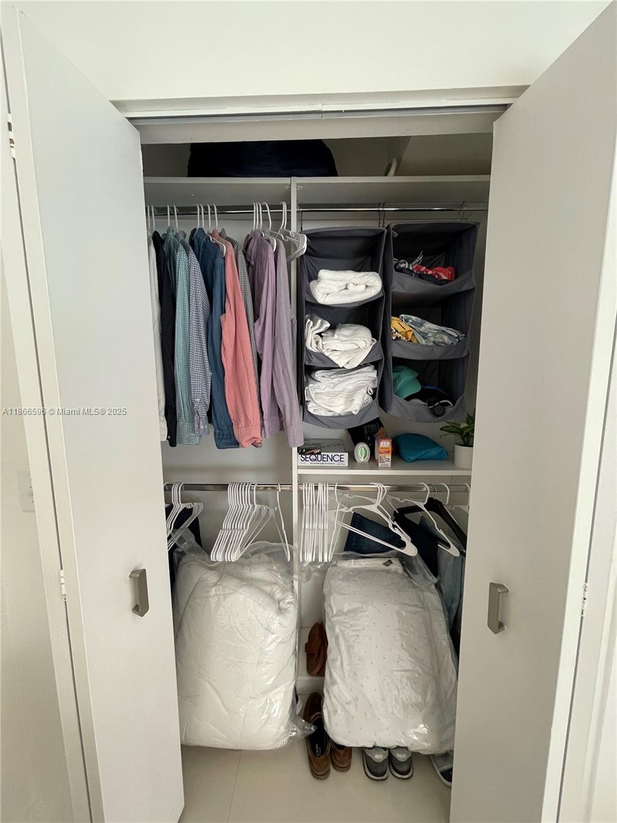 1604 Drexel Avenue, Unit 209 Miami Beach, FL 33139 - Photo 8 of 9 a view of walk in closet with clothes and shoes