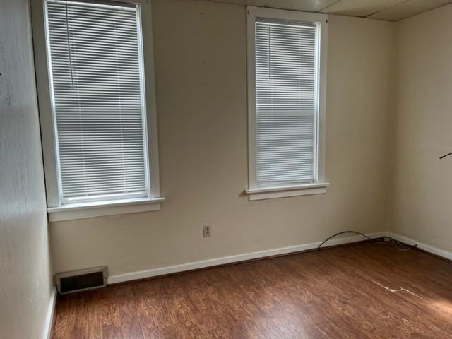 299 Reno Street Rochester, PA 15074 - Photo 3 of 12 a view of an empty room with wooden floor and a window