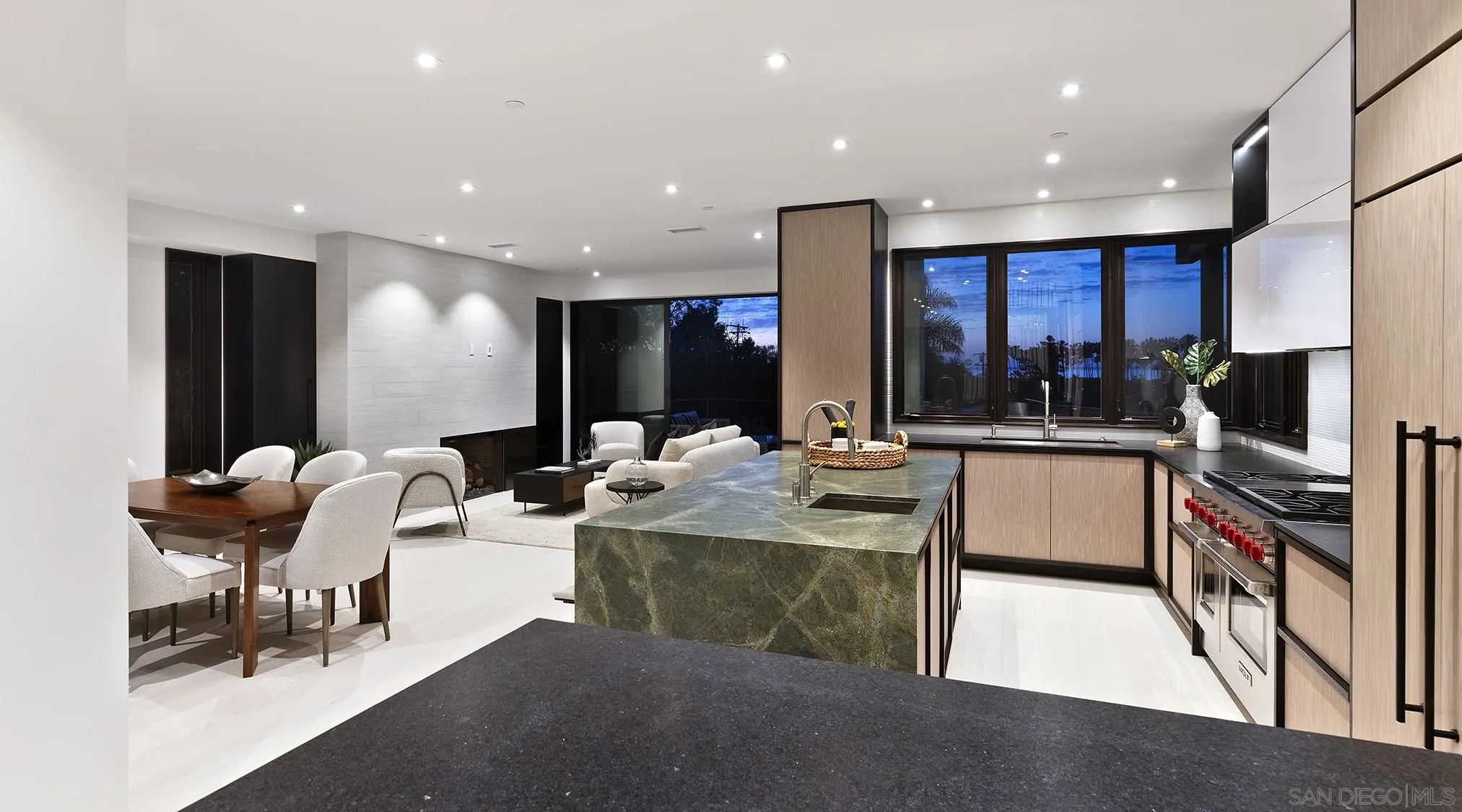 2045 Lowry Place La Jolla, CA 92037 - Photo 12 of 52 a large kitchen with stainless steel appliances kitchen island granite countertop a table and chairs