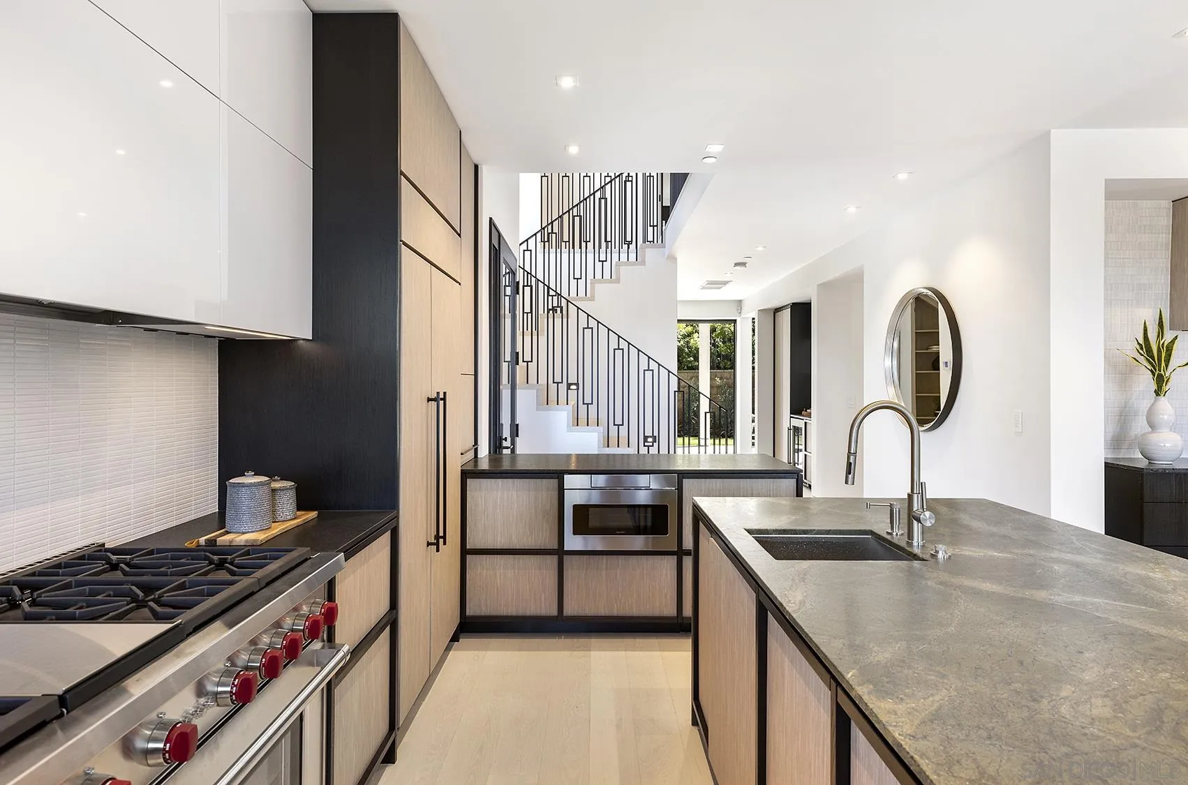 2045 Lowry Place La Jolla, CA 92037 - Photo 25 of 52 a kitchen with stainless steel appliances granite countertop a sink stove and cabinets
