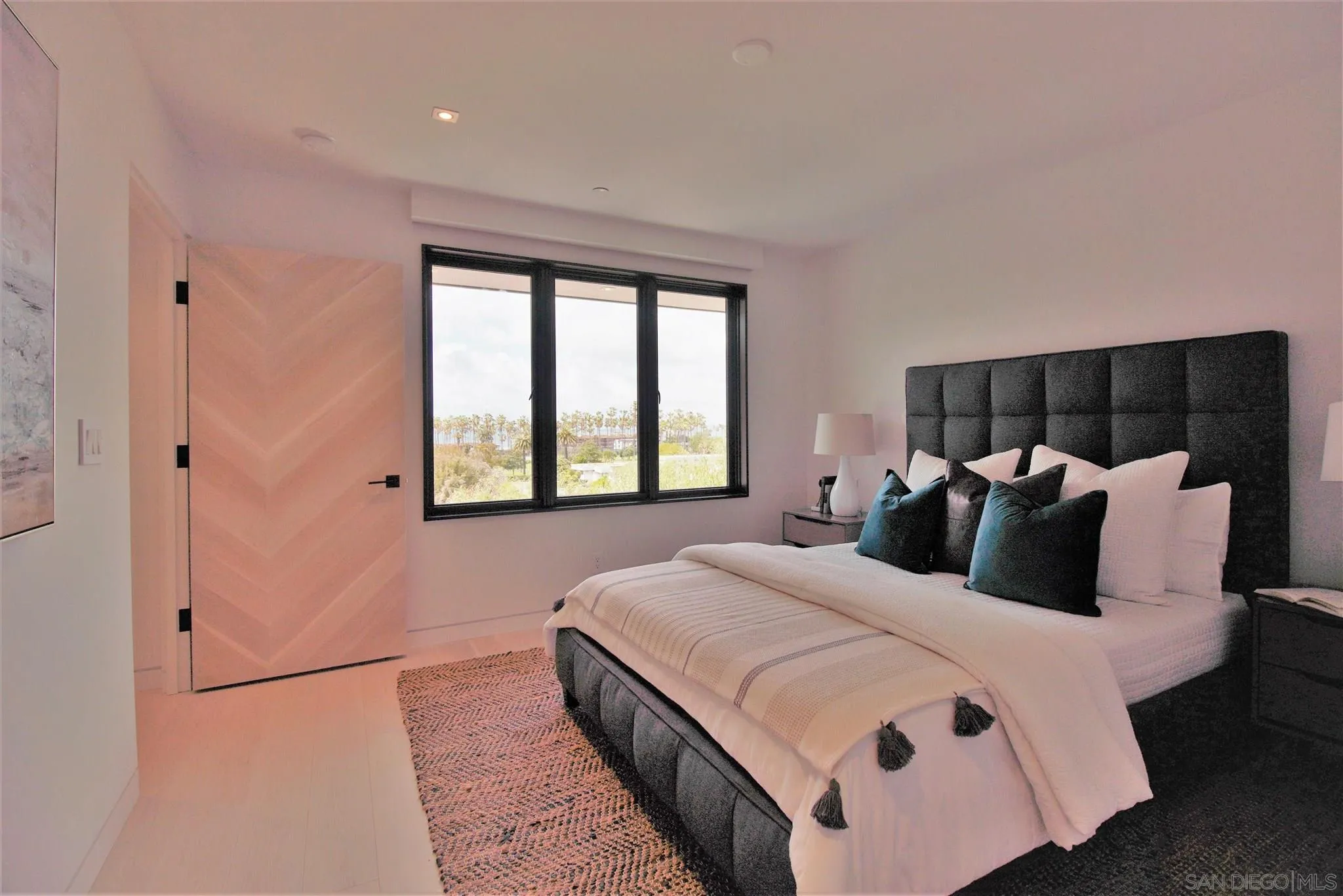 2045 Lowry Place La Jolla, CA 92037 - Photo 45 of 52 a bedroom with a large bed and a large window