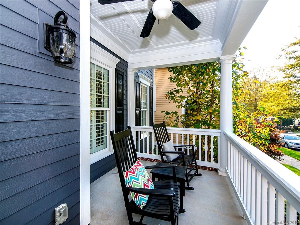 664 Revival Row, Unit 1077 Fort Mill, SC 29708 - Photo 3 of 24 a view of a patio with a table chairs and a floor to ceiling window