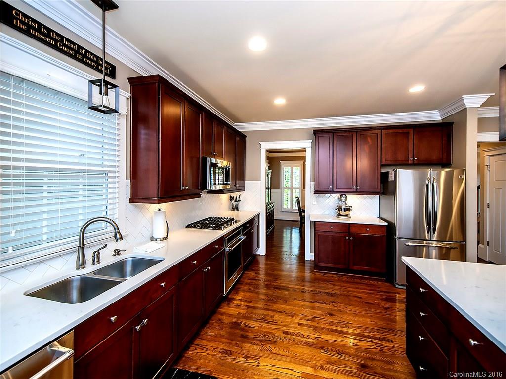 664 Revival Row, Unit 1077 Fort Mill, SC 29708 - Photo 8 of 24 a kitchen with stainless steel appliances granite countertop a sink stove and refrigerator