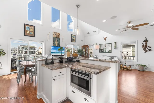 a kitchen with a stove and a wooden floors