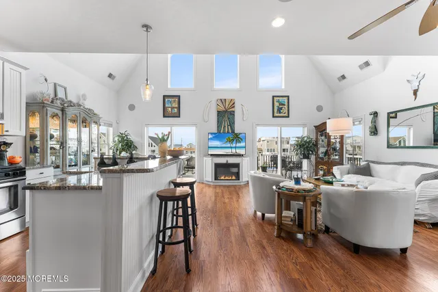 a living room with fireplace furniture and a wooden floor