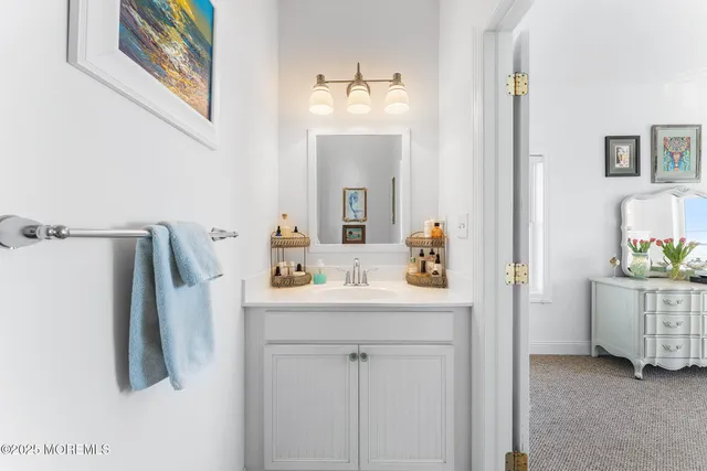 a bathroom with a sink vanity and a mirror