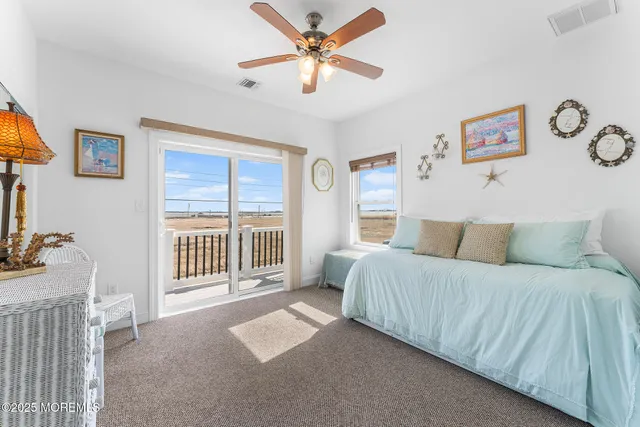 a spacious bedroom with a balcony a bed and a window