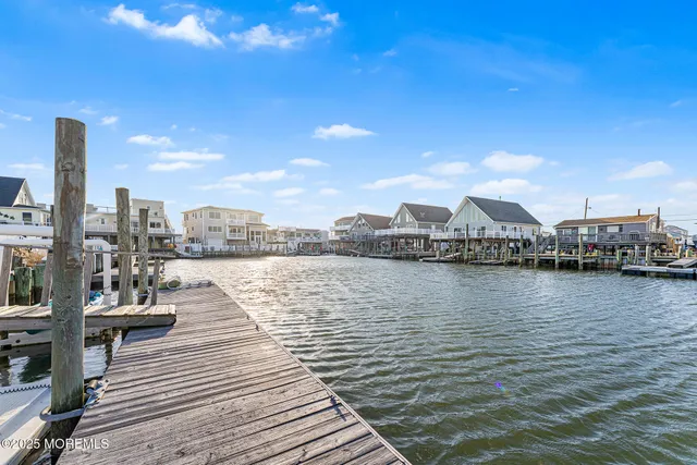 a view of a ocean with boats and trees in the background
