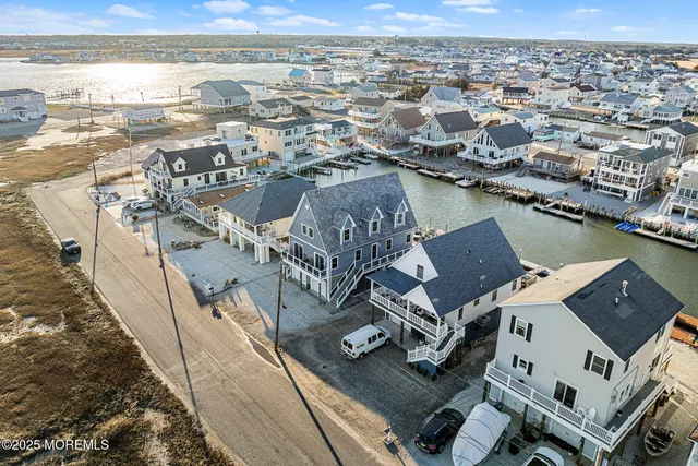 a view of a big house with a big yard and large trees