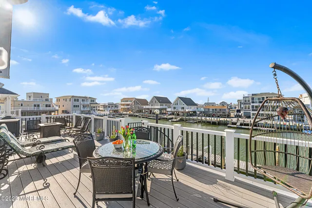 a view of a chairs and table in the balcony