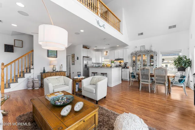 a living room with furniture kitchen view and a dining table