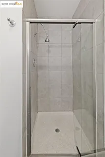 a bathroom with a granite countertop toilet sink and mirror