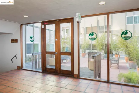 a kitchen with kitchen island a stove a refrigerator and a sink