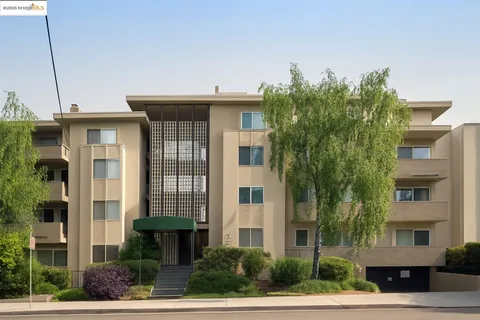 a front view of a building with tree s