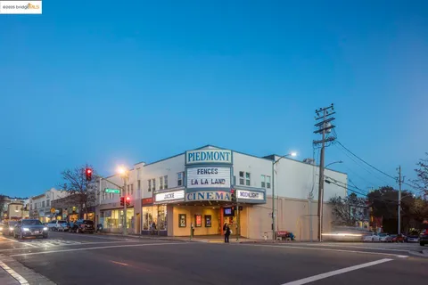 a front view of a residential apartment building with a yard