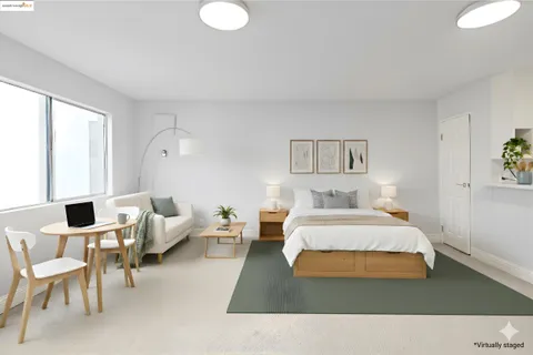a view of a kitchen with refrigerator and white cabinets