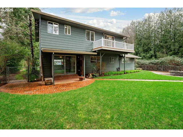 a view of a house with a yard and sitting area