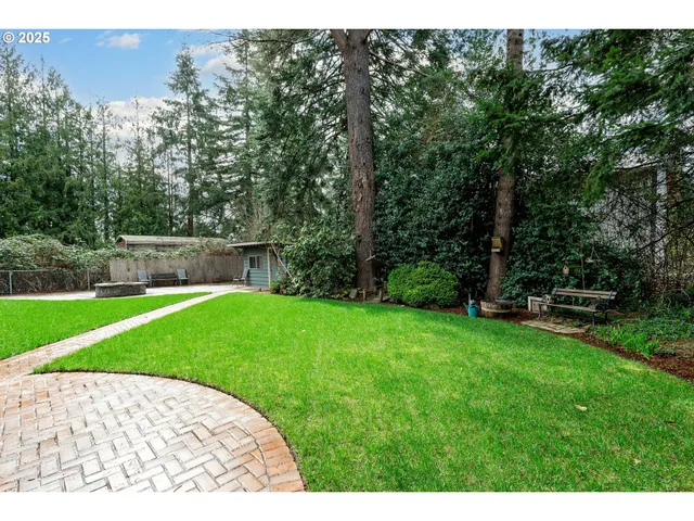 a view of a backyard with a garden and trees