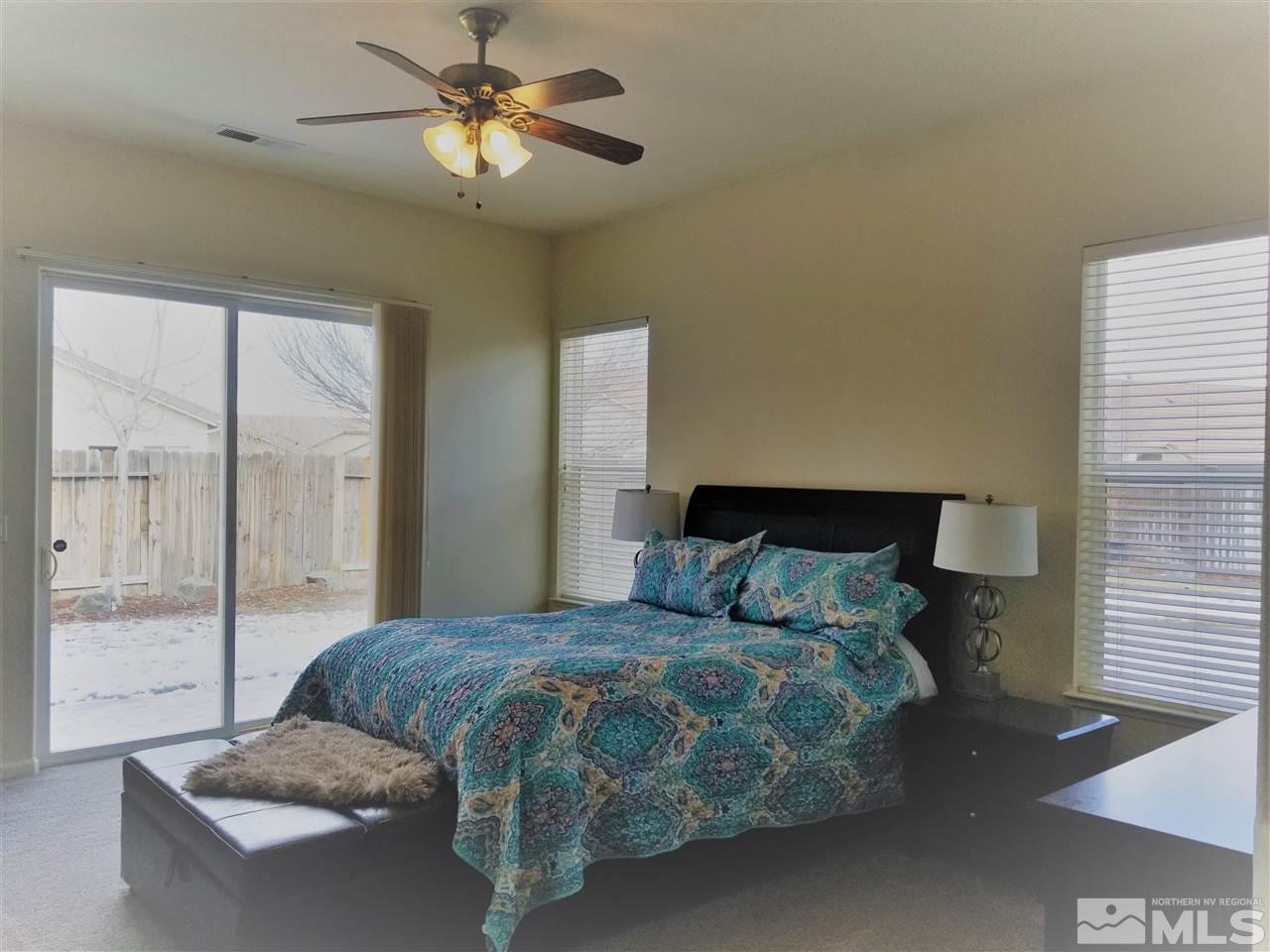 9625 Glen Ridge Drive Reno, NV 89521 - Photo 13 of 23 a bedroom with a bed and glass door