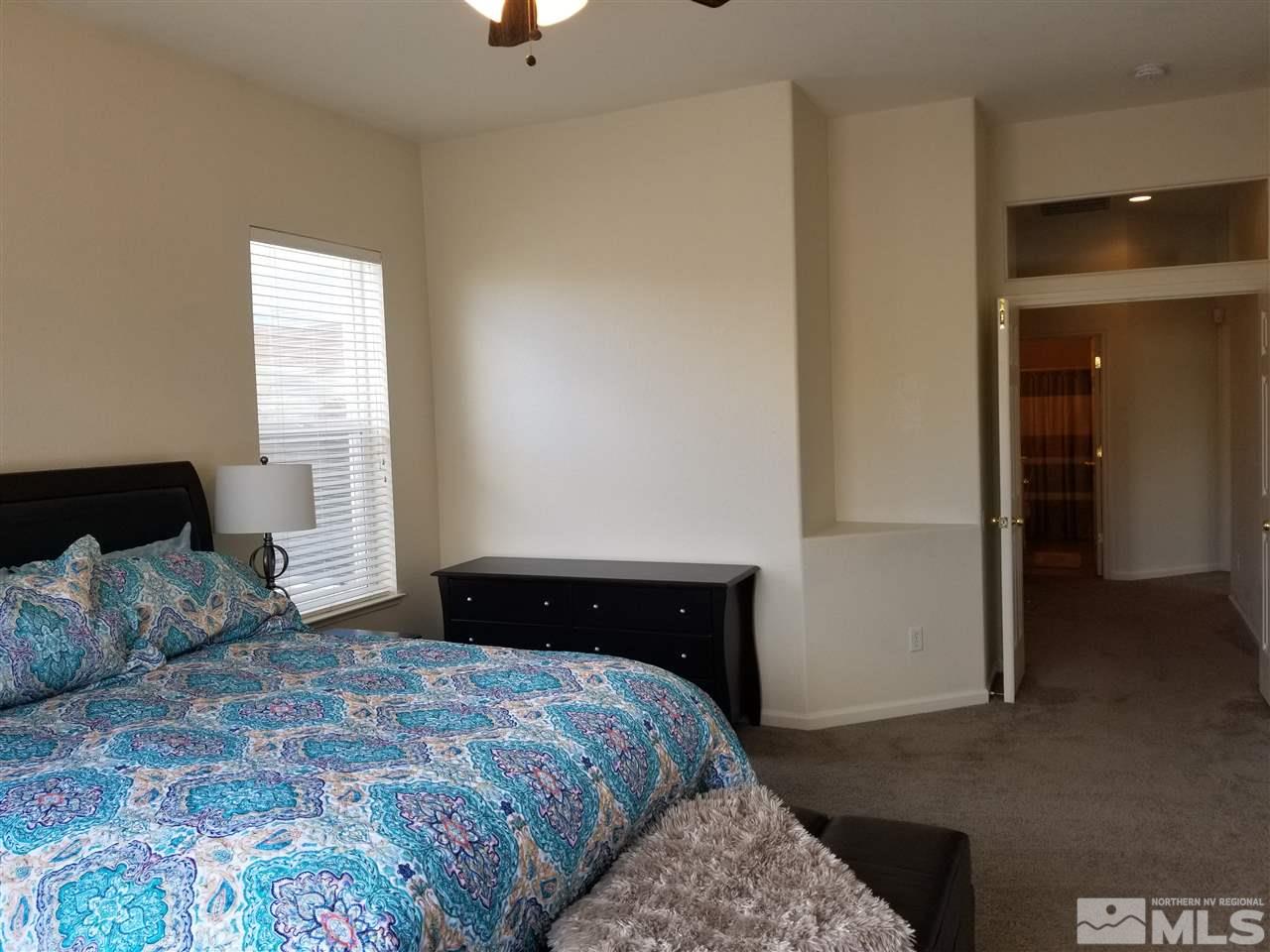 9625 Glen Ridge Drive Reno, NV 89521 - Photo 14 of 23 a bedroom with a bed and a lamp