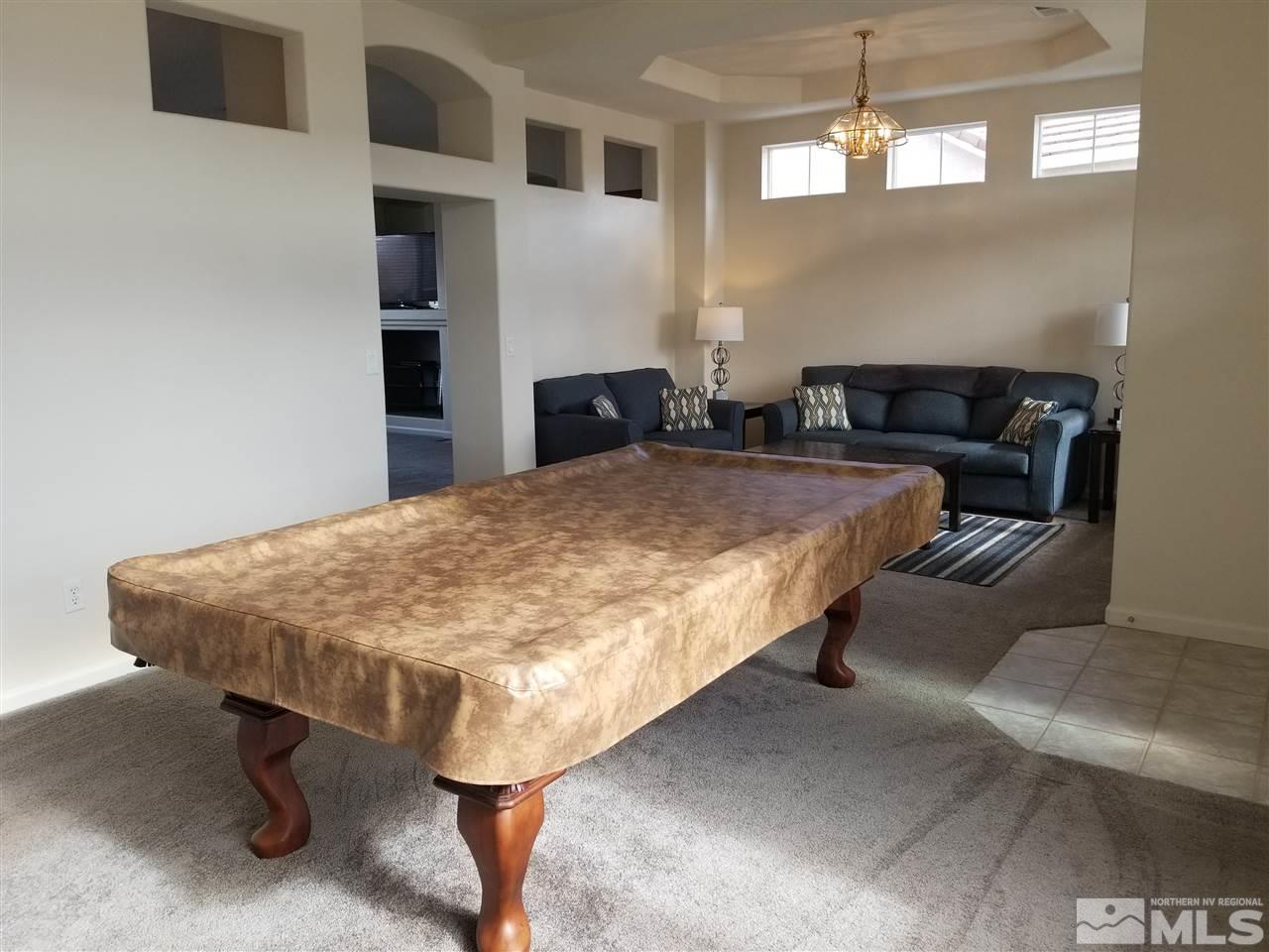 9625 Glen Ridge Drive Reno, NV 89521 - Photo 3 of 23 a bed sitting in a bedroom and kitchen view