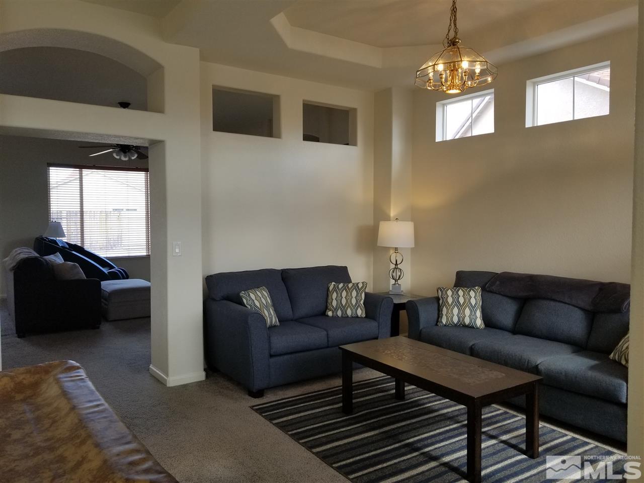 9625 Glen Ridge Drive Reno, NV 89521 - Photo 4 of 23 a living room with furniture and a chandelier