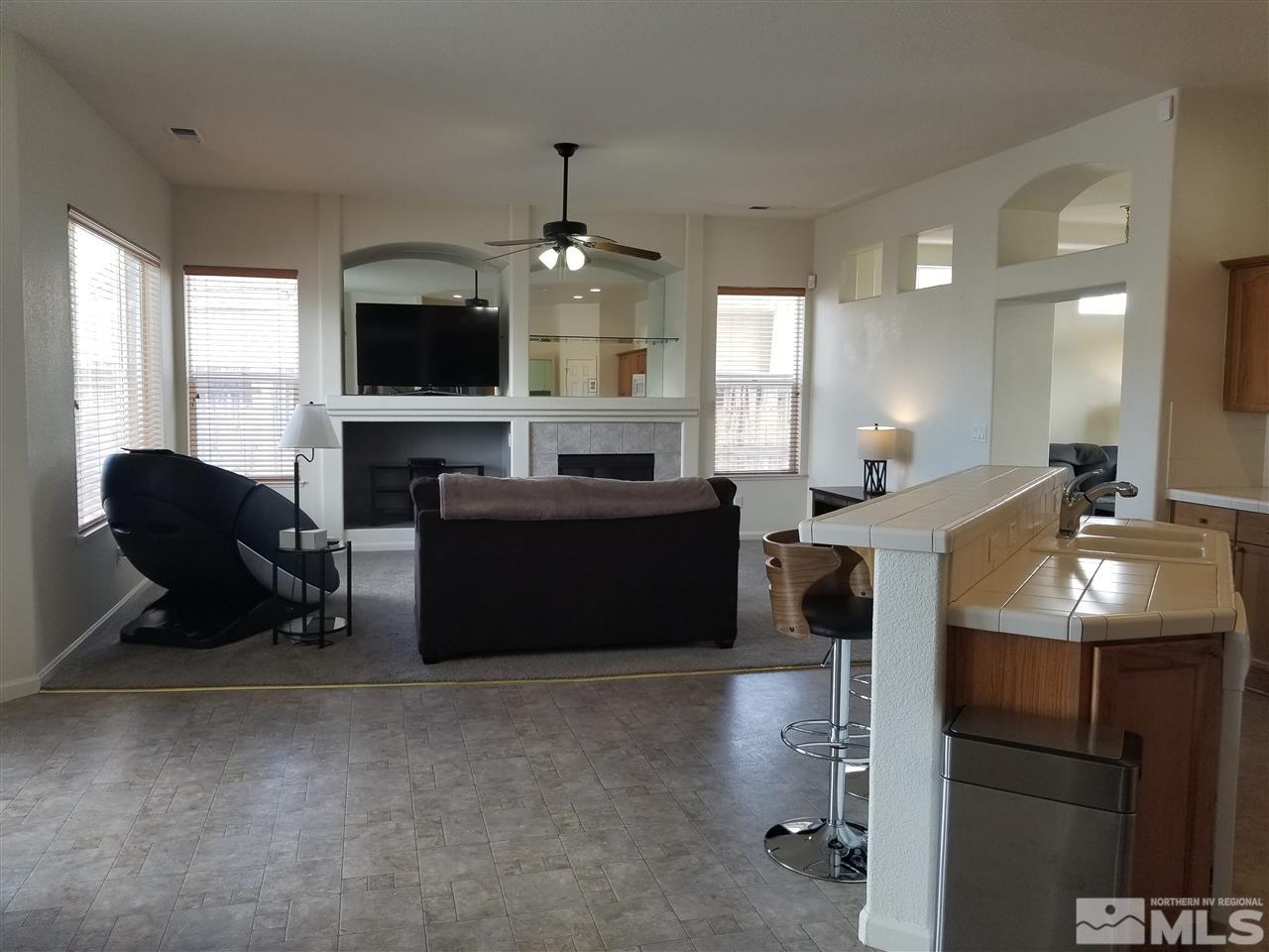 9625 Glen Ridge Drive Reno, NV 89521 - Photo 7 of 23 a living room with furniture a flat screen tv and a large window
