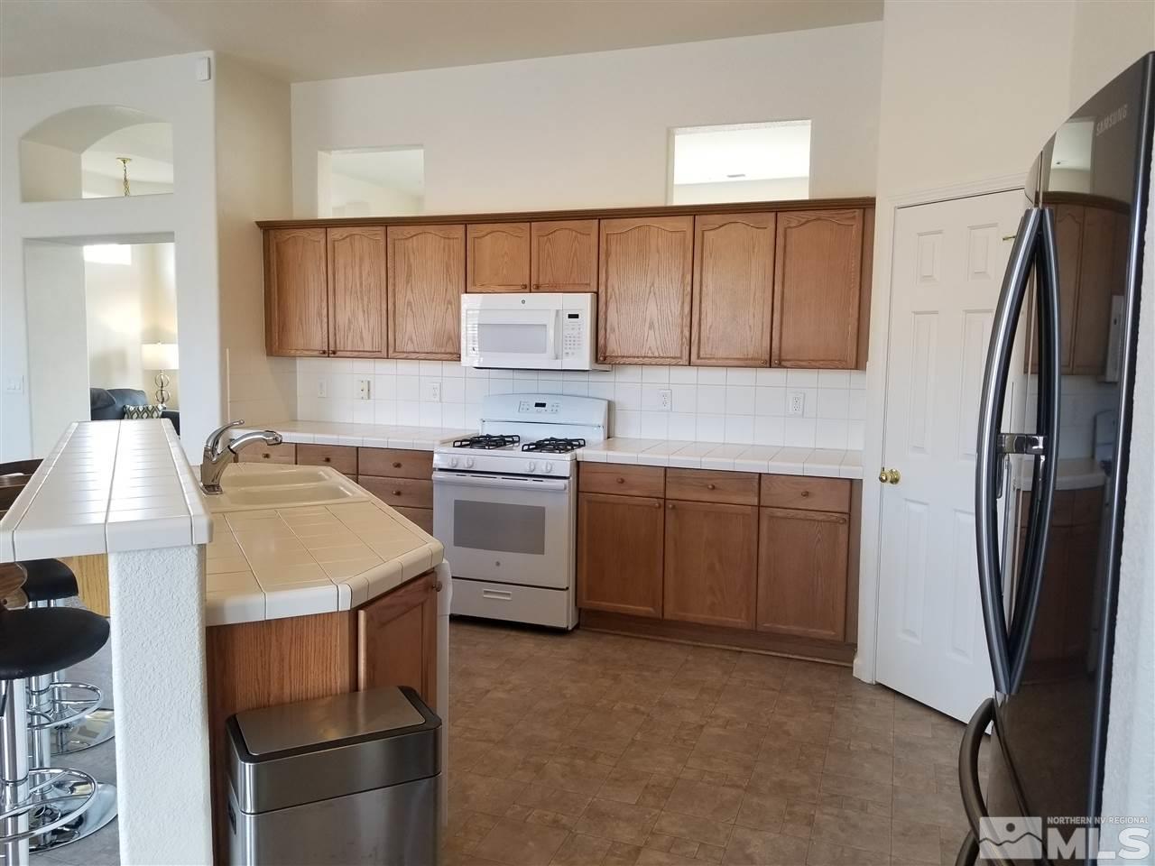 9625 Glen Ridge Drive Reno, NV 89521 - Photo 10 of 23 a kitchen with a sink appliances and cabinets