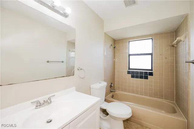 a bathroom with a sink toilet vanity and shower