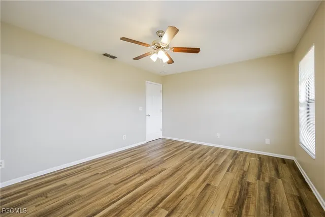 wooden floor in an empty room with a window