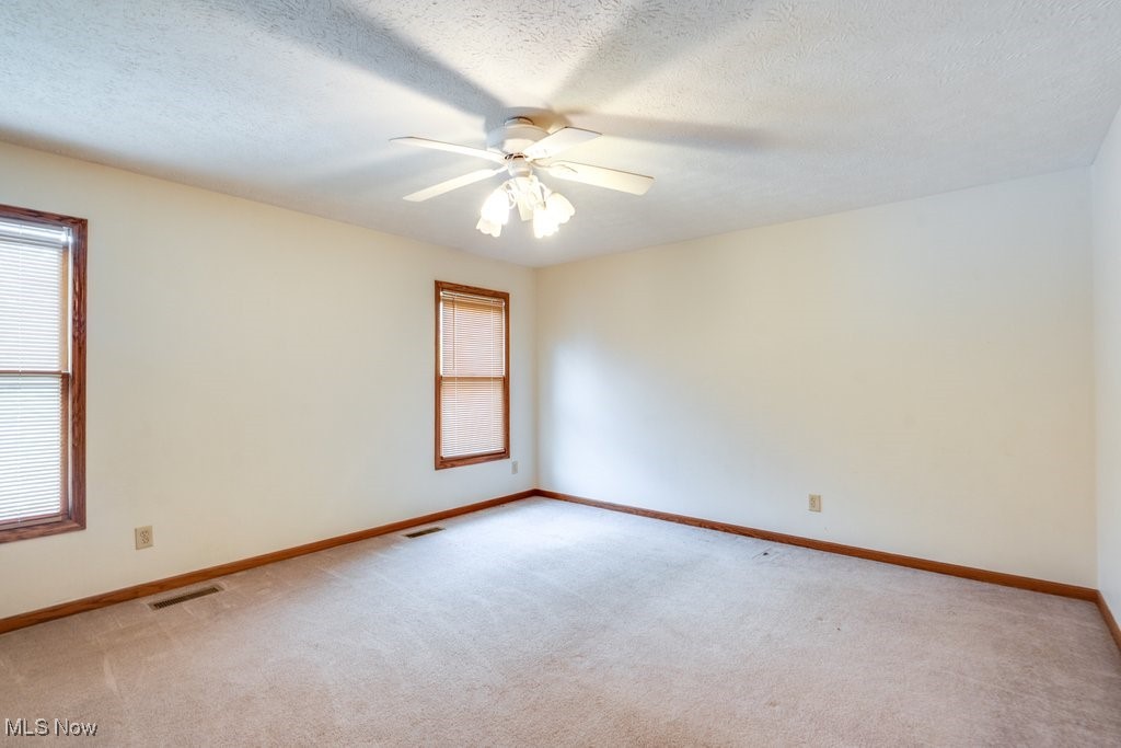 3362 Sunnybrook Road Kent, OH 44240 - Photo 24 of 50 Carpeted spare room featuring ceiling fan and a textured ceiling