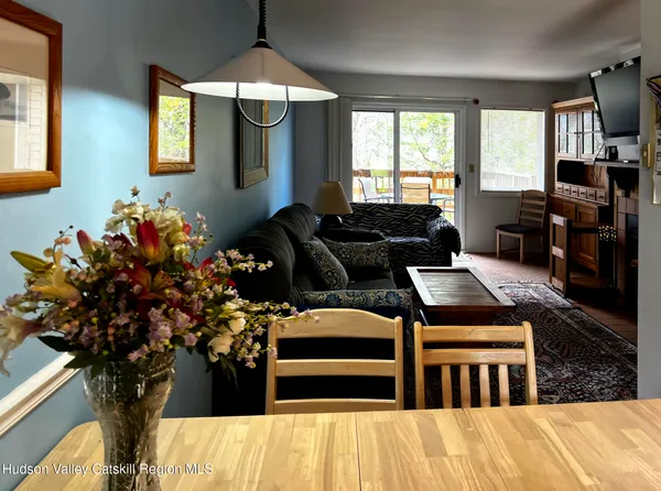 a living room with furniture fireplace and flower pot