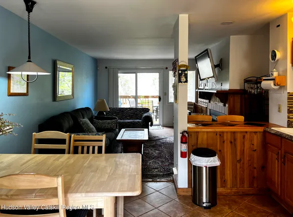 a living room with furniture a window and kitchen view