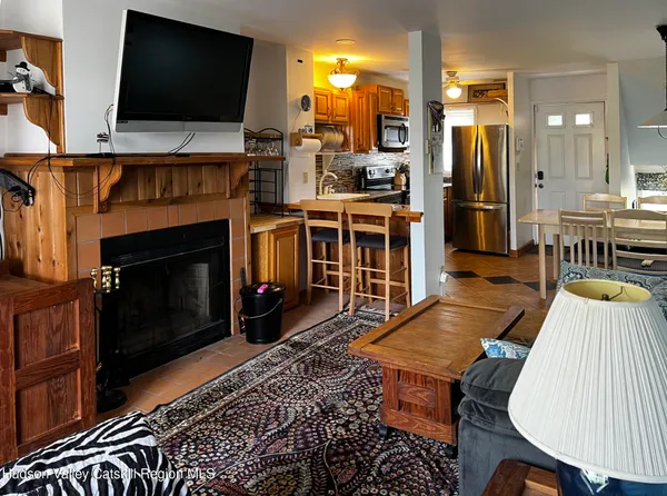 a living room with furniture fireplace and flat screen tv