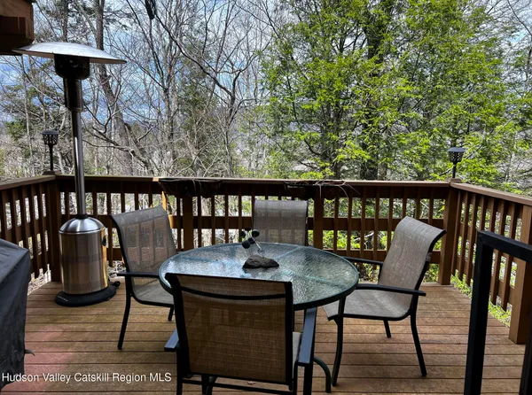 a view of a chairs and table on the deck