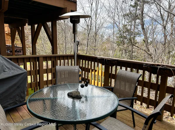 a view of a chairs and table in the balcony