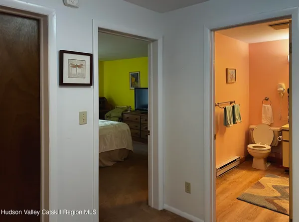 a bathroom with a granite countertop toilet and a shower