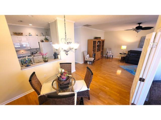 427 Colonial Trace Drive, Unit 1E Longs, SC 29568 - Photo 11 of 35 Dining area featuring ceiling fan with notable cha