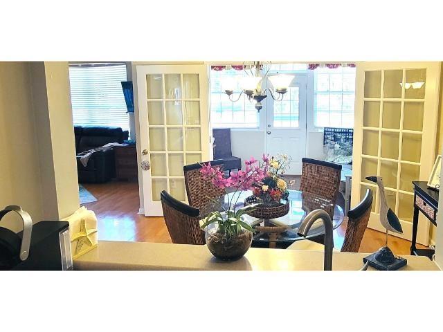 427 Colonial Trace Drive, Unit 1E Longs, SC 29568 - Photo 17 of 35 Dining space featuring a chandelier, french doors,