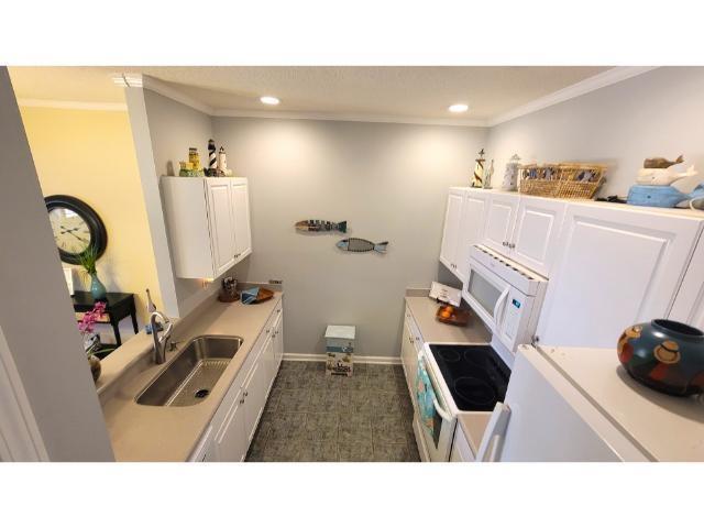 427 Colonial Trace Drive, Unit 1E Longs, SC 29568 - Photo 19 of 35 Kitchen featuring crown molding, sink, white cabin