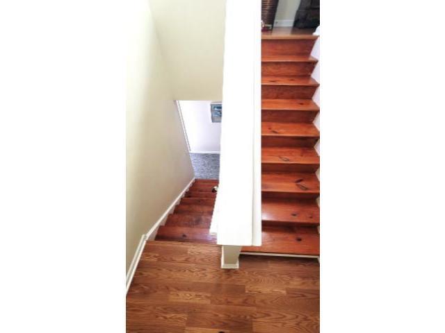 427 Colonial Trace Drive, Unit 1E Longs, SC 29568 - Photo 21 of 35 Stairway featuring hardwood / wood-style flooring