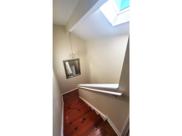 427 Colonial Trace Drive, Unit 1E Longs, SC 29568 - Photo 22 of 35 Stairway featuring wood-type flooring and lofted c