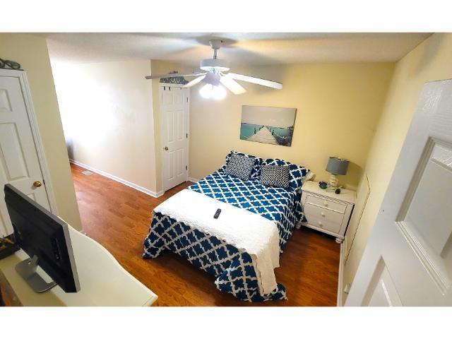 427 Colonial Trace Drive, Unit 1E Longs, SC 29568 - Photo 23 of 35 Bedroom featuring ceiling fan and dark wood-type f