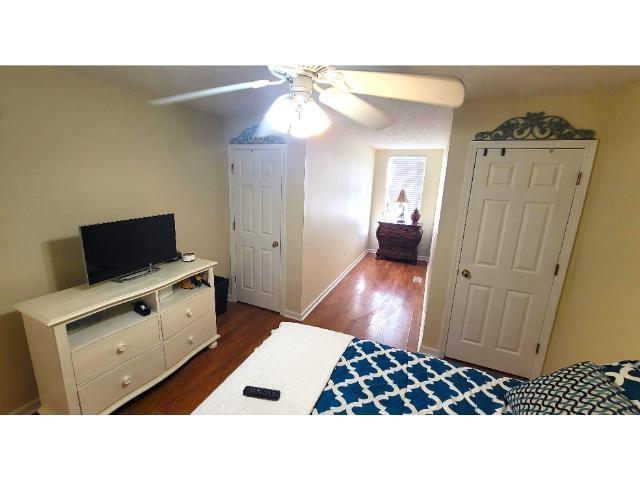 427 Colonial Trace Drive, Unit 1E Longs, SC 29568 - Photo 24 of 35 Bedroom with ceiling fan and dark wood-type floori