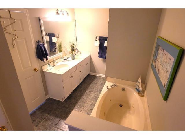 427 Colonial Trace Drive, Unit 1E Longs, SC 29568 - Photo 8 of 35 Bathroom with vanity and a tub to relax in