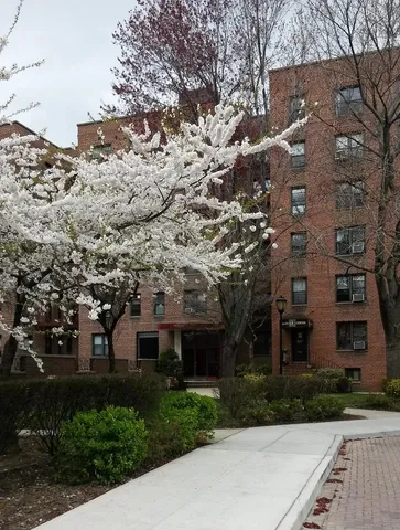 a large building with trees in front of it