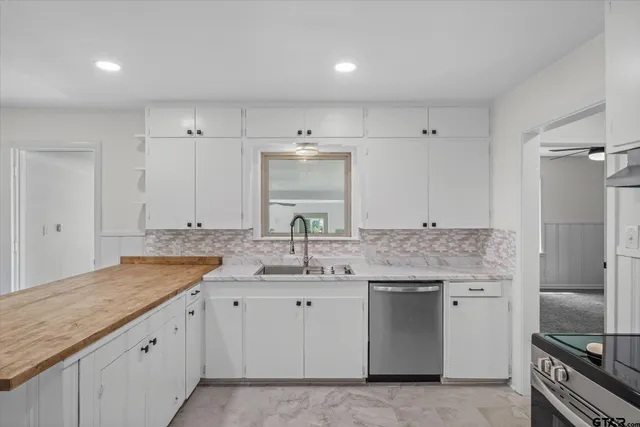 a bathroom with a granite countertop double sink and a mirror
