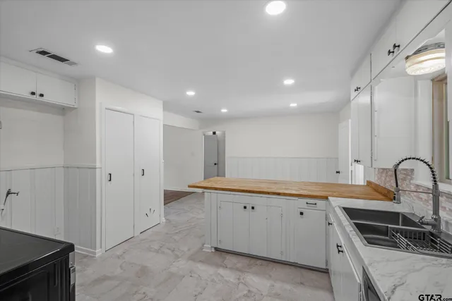 a kitchen with stainless steel appliances granite countertop a sink and cabinets
