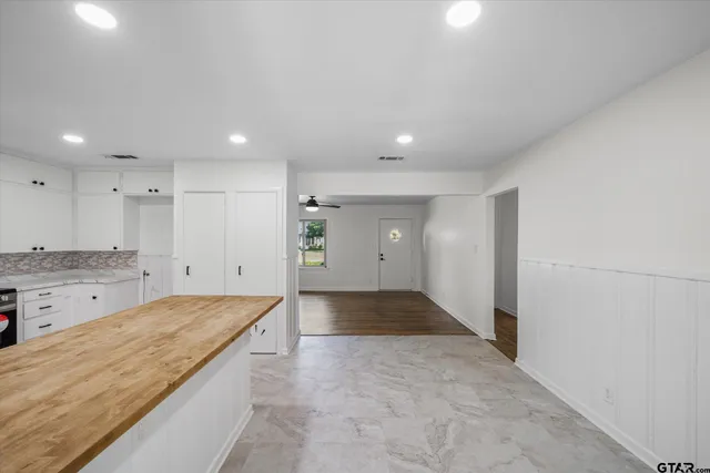 a large bathroom with a granite countertop sink and a large mirror